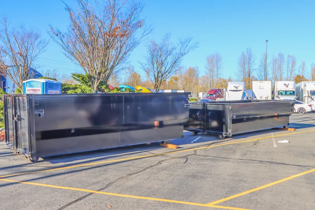 Professional dumpster rental service with roll-off container on residential driveway in Fairhope